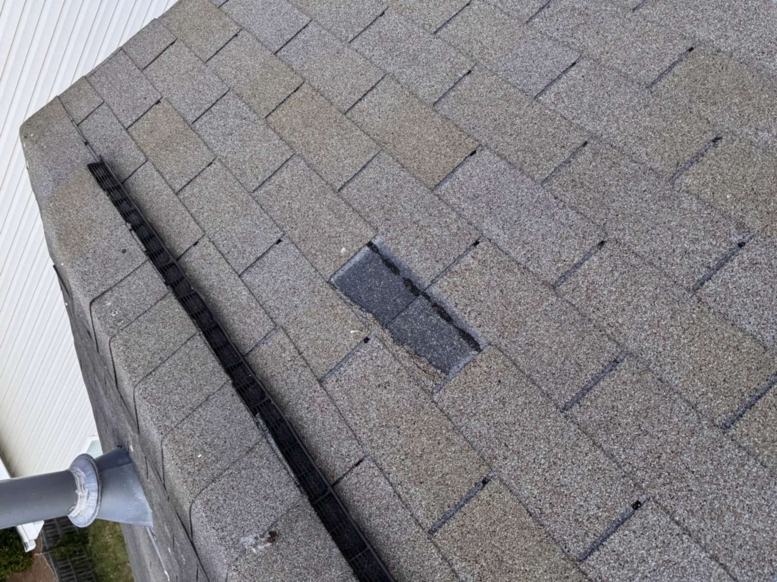Aging asphalt shingle roof with lifted and damaged shingles
