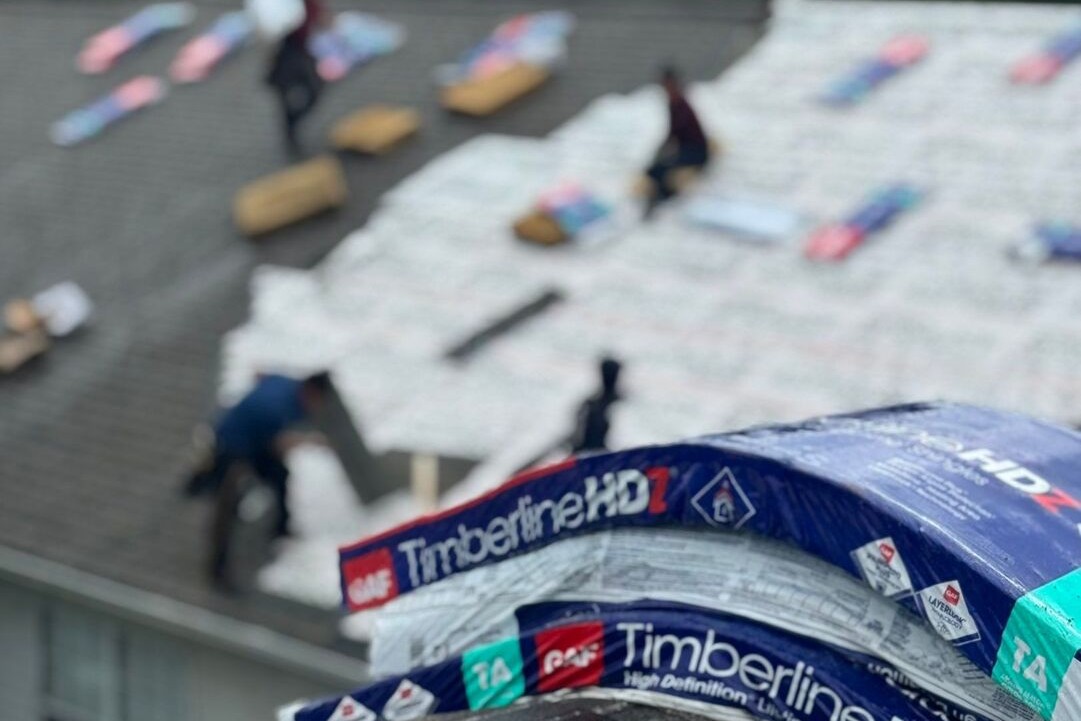 Bundles of GAF shingles staged on a roof
