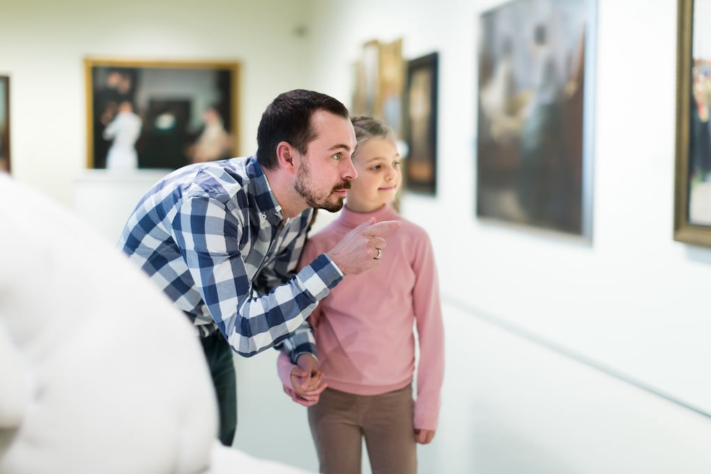 father and daughter visiting an art museum