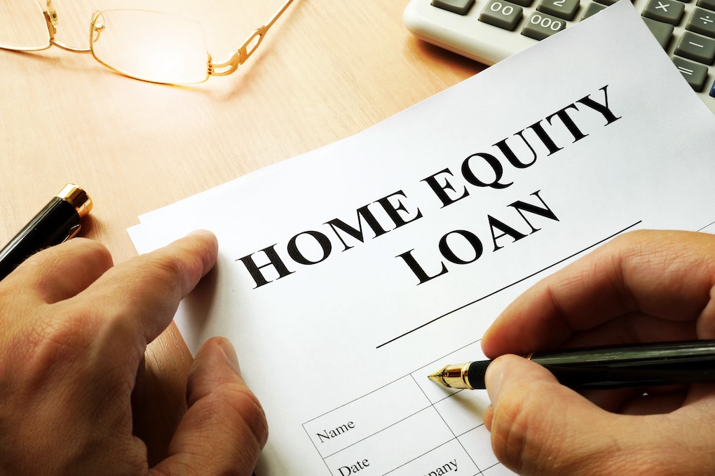 home equity loan on a desk with a man signing it as roof financing options