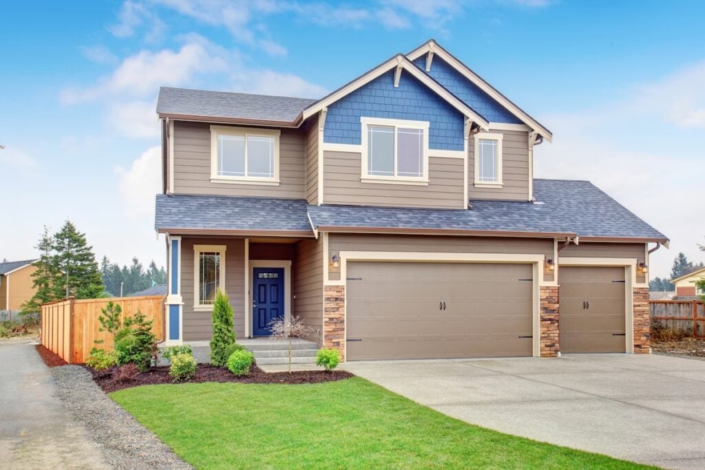 Beautiful traditional home with garage and driveway.