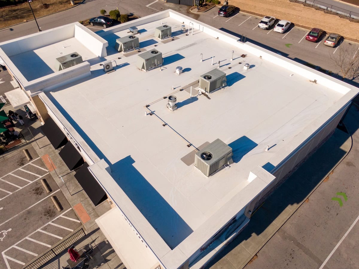 Sunny Day Time Drone Images of a TPO Roof on a Commercial Building.