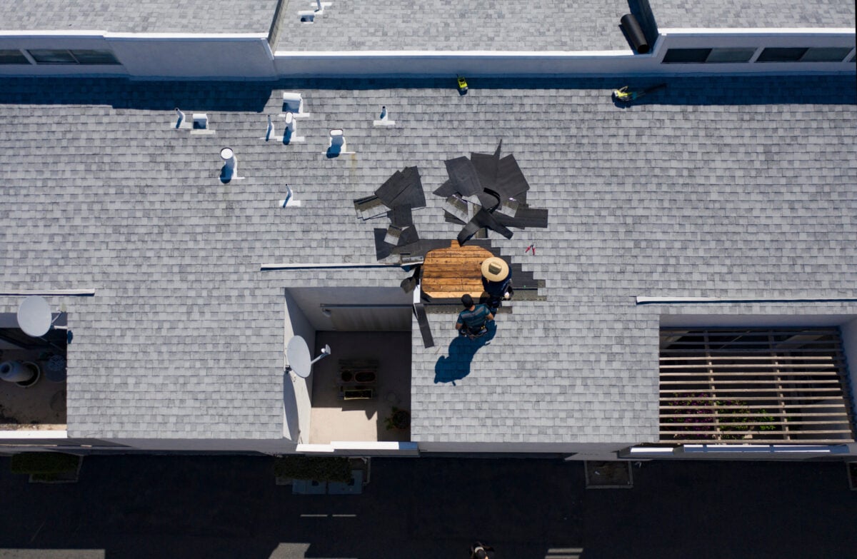 Roof Repair Inspection In Progress Aerial Above Head Condo Building Gray Shingles 2 Roofers commercial roof leak repair
